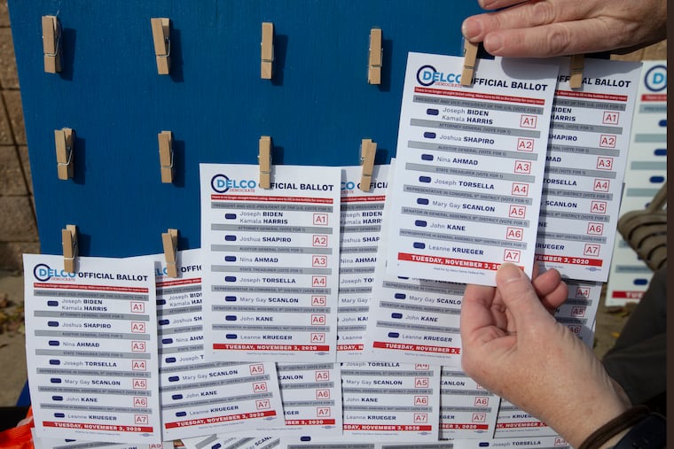Florence Moyer refills the Democratic ballots outside a polling location in Brookhave, Delaware County.