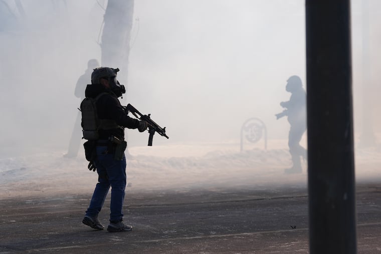 Federal immigration officers deploy tear gas after Border Patrol agents shot and killed Alex Pretti in Minneapolis, on Saturday.