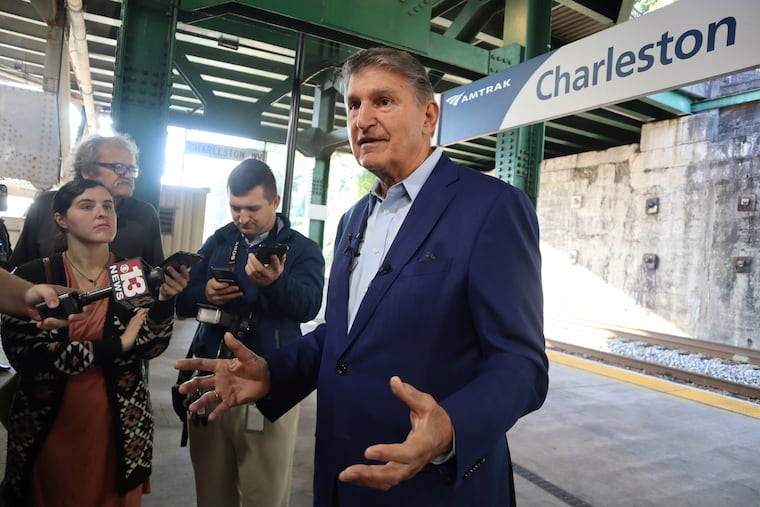 West Virginia Democratic Sen. Joe Manchin speaks with reporters outside the newly renovated Amtrak train station in Charleston, W. Va.