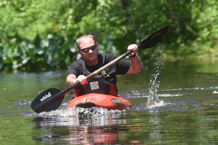 John Anderson of Westampton, a fan of Rancocas Creek, paddles his kayak in the creek in Mount Holly near Mill Dam Park. “All you hear is nature,” he said. “It’s hypnotic. It’s an escape from everything around us.” (CURT HUDSON / For The Inquirer)