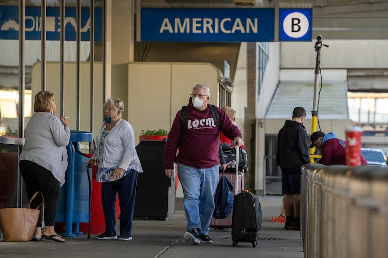 Travelers outside American Airlines' Terminal B at Philadelphia International Airport last month.