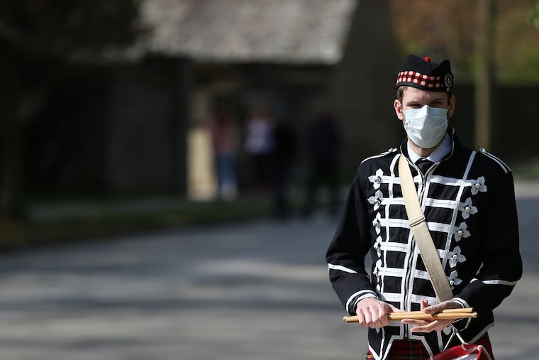 In Philadelphia's Chestnut Hill neighborhood, Church of St. Martin-in-the-Fields organized a socially distanced Easter parade with two bagpipe players and a drummer to perform traditional Easter hymns on Sunday. Drummer Corey Purcell, of Allentown, pauses along Willow Grove Avenue.