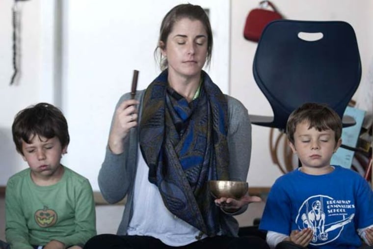 Kindergarten teacher Erica Eihl leads the meditation with Lucas Gold (left) and Husam Arab at Citizens of the World Mar Vista in Culver City, Calif.
