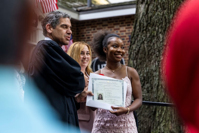 Wilma Athen Kollie, 29, of Bristol, Pa., receives her certification for her citizenship by Judge Joshua D. Wolson during the ceremony for her naturalization at the Betsy Ross House in 2021. Kollie is originally from Liberia and has been living in the states since 2003. “It feels amazing, and it feels like a long time coming,” Kollie said. “As far as opportunities, since I immigrated here I was exposed to a lot of different things. A chance to finally call myself a United States citizen. It’s a really big deal for me.”