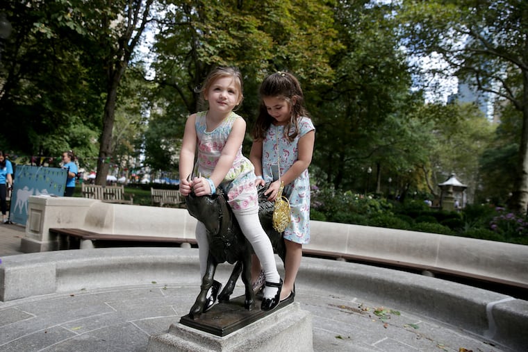 Hattie Morin, 3, (left) and her sister Ruby Morin, 5, sit on the new Billy in Rittenhouse Square.