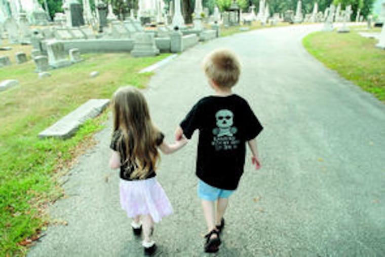So cute you could just die: Faith Eternity Renalli-Del Rosario and Joe Holtzinger stroll hand in hand in Laurel Hill Cemetery. Faith's mother organizes social events for a group of Philadelphia-area fun-loving goth parents through Meetup.com, with 73 members, and runs an occasional club dance party called Kinderbats for parents and kids.