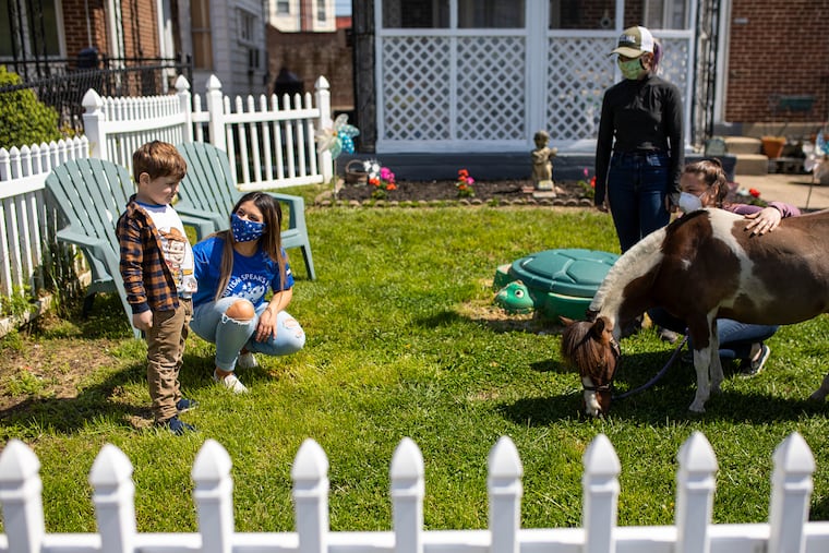 Lauren Maqboul, 22, is with her son Cameron Maqboul, 4, as they are visited by Big Mac, a miniature horse from Pegasus Therapeutic Riding Academy on Saturday, April 25, 2020. Cameron is diagnosed with nonverbal autism and began horse therapy sessions at Pegasus in January before the coronavirus outbreak closed the facility.