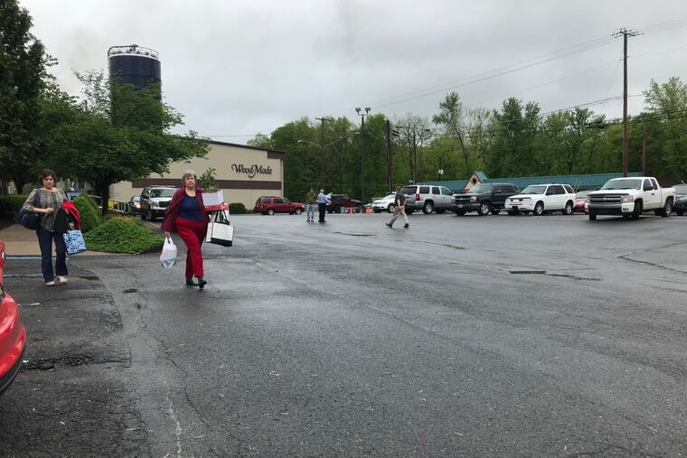 Employees walk out of Wood-Mode in Kreamer on Monday, May 13, 2019, after employees were informed the custom-cabinet maker is closing permanently.