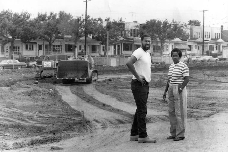 Osage Ave. and Pine St. house developers Beverly Harper and Ernest Edwards walk around the site as bulldozers level off ground in preparation for construction.