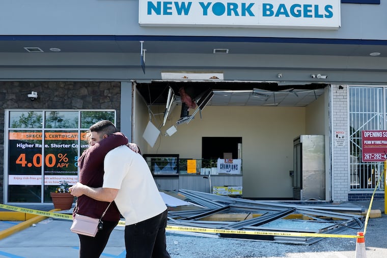 New York Bagels owner Rayyan Kayyali receiving a hug from customer Kari Kohm hours after the explosion at the bakery on May 10, 2026.