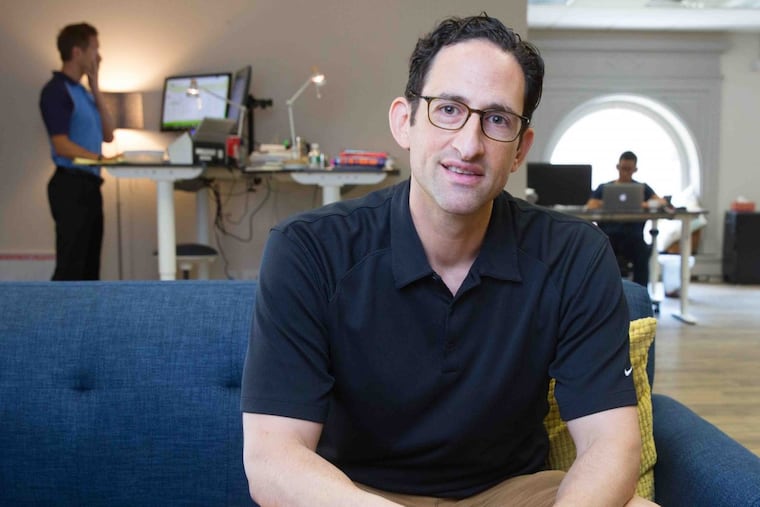 Adam Holt, founder and CEO of Asset-Map, in his office in the Bourse building. ( JESSICA GRIFFIN / Staff Photographer )