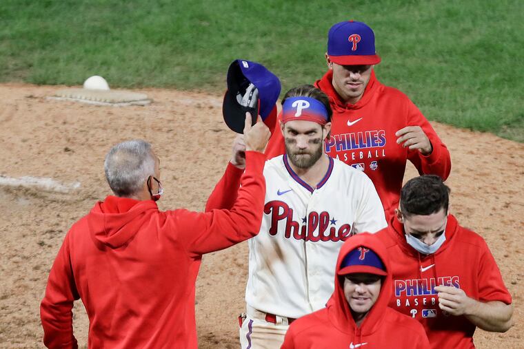 Manager Joe Girardi (left) and the Phillies will finish the regular season this weekend in Tampa Bay.