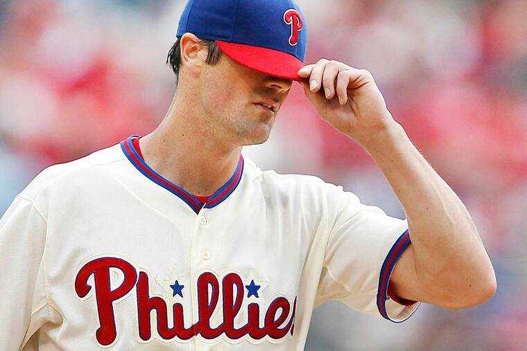 Phillies' Cole Hamels adjusts his cap after giving up a two-run homer to Cleveland Indians' Nick Swisher in the 5th inning at Citizens Bank Park in Philadelphia, Pennsylvania, Wednesday, May 15, 2013. (David Maialetti/Philadelphia Daily News/MCT)