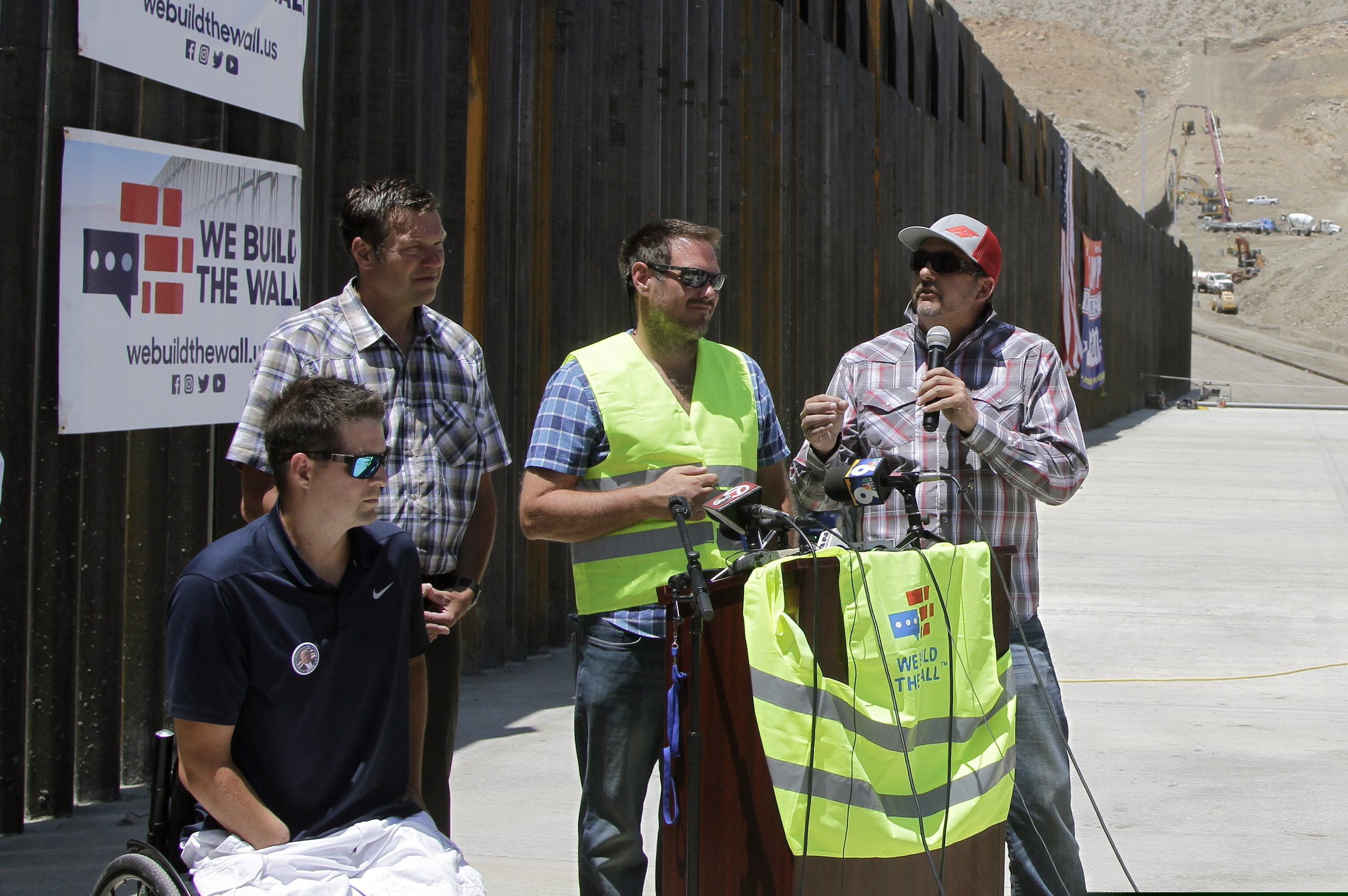 Leaders of We Build the Wall Inc. discuss plans for future barrier construction along the U.S.-Mexico border, Thursday, May 30, 2019, in Sunland Park, N.M. The group expects to finish a segment of 2,300 feet of bollard-style fencing on private land, after raising around $23 million through a crowd-funding website. Organizers say it will have money left over for future projects. (AP Photo/Cedar Attanasio)