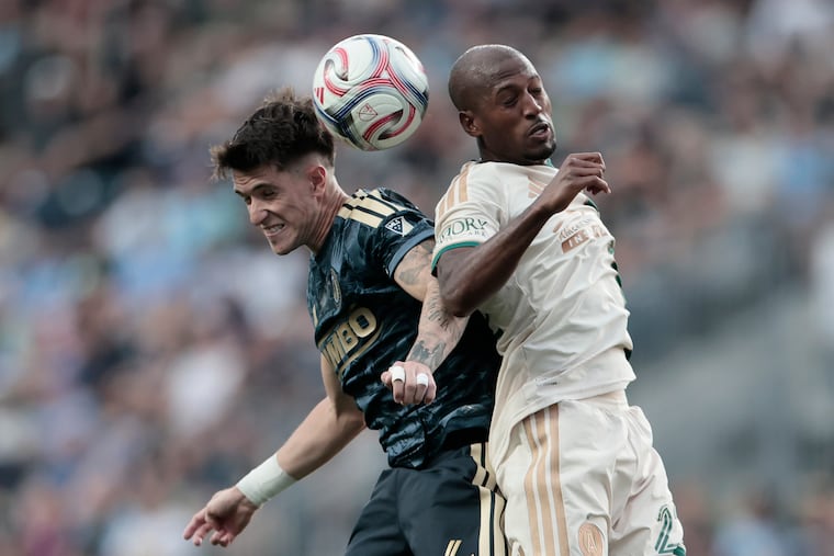 The Union's Jovan Lukić (left) and Atlanta United’s Fafa Picault battle for a ball in the first half on Saturday at Subaru Park.