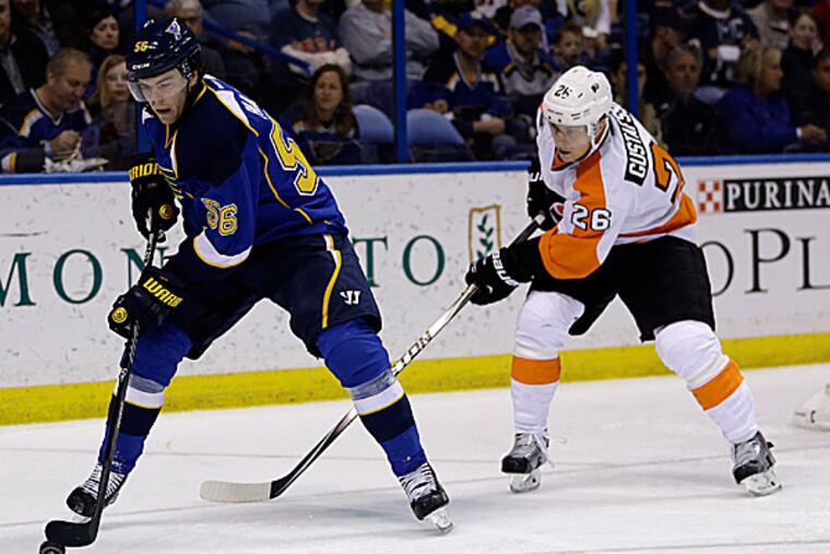 The Blues' Magnus Paajarvi handles the puck as the Flyers' Erik Gustafsson gives chase. (Jeff Roberson/AP)