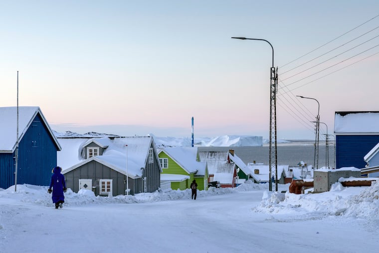 Pedestrians walk on Jan. 17, 2025, in Ilulisaat, Greenland, a town where a Chinese state company nearly won a contract to build an airport in 2018.
