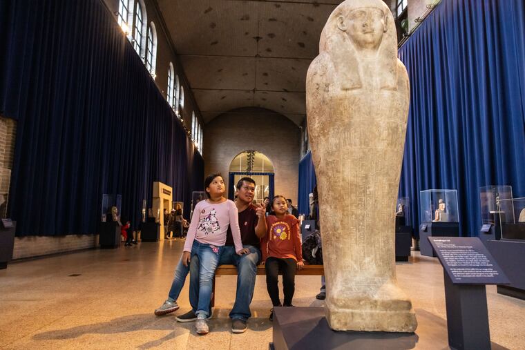 A family views an exhibit in the Egypt Gallery of the Penn Museum. It will close Nov. 6 to allow construction of the museum's new Ancient Egypt and Nubia galleries.