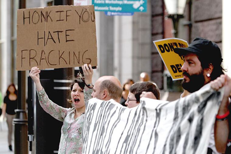 Earth First! held a "noise demo" Wednesday morning outside the Shale Gas Insight Conference. The Marcellus Shale Coalition has taken out demonstration permits itself "to ensure that our nearly 2,000 participants can enter and exit the convention center safely and with limited harassment from the few dozen who might be demonstrating on the outside.” ( CHARLES FOX / Staff Photographer )