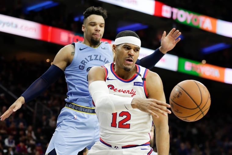 Sixers forward Tobias Harris passing the basketball past Memphis Grizzlies guard Dillon Brooks during a February game.