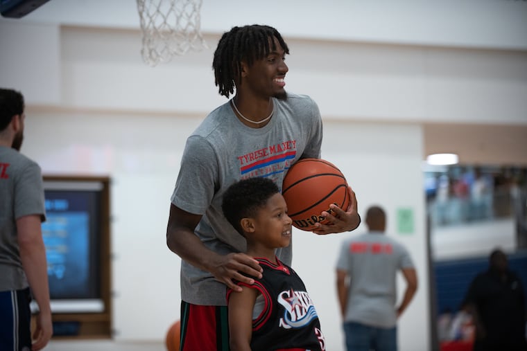 Tyrese Maxey poses for a photo with a participant of his basketball clinic at Penn Charter School in North Philadelphia on Saturday, August 6, 2022. The camp welcomed players for a free day of playing and learning with the Philadelphia Sixers guard.