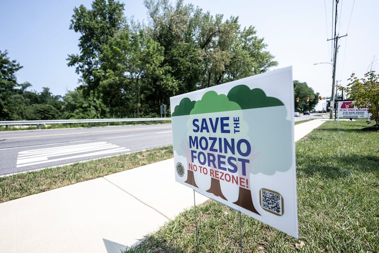 Residents of Upper Darby Township are rallying to protect 15 acres of land from being developed as a mixed-use retail and residential site. A "Save the Mozino Forest" sign is pictured across the street from the site in Upper Darby.