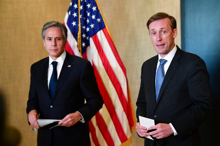 Secretary of State Antony Blinken (left) listens as national security adviser Jake Sullivan (right) talks to the media after a closed-door morning session of U.S.-China talks in Anchorage, Alaska, on Friday, March 19, 2021.