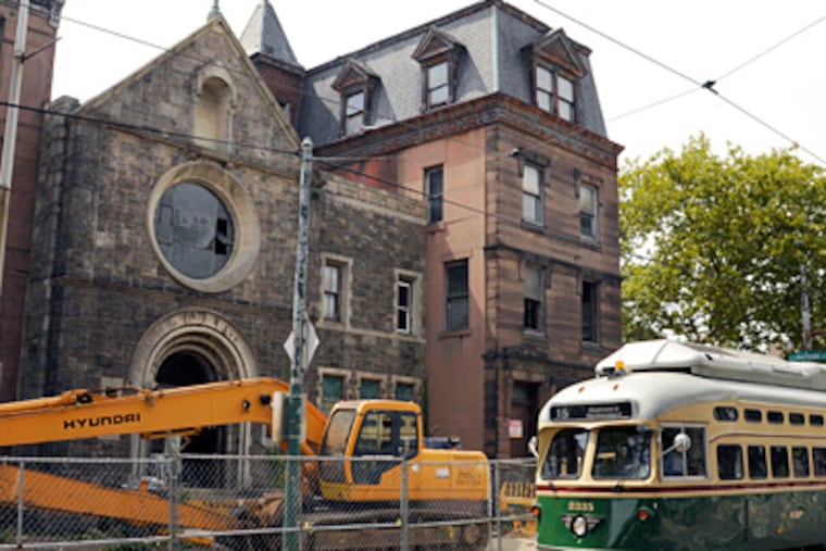 The former monastery at Girard and Corinthian Avenues is now a fenced-off construction site as demolition begins.