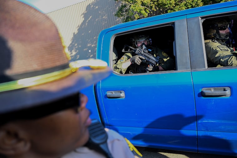 Federal agents in a pickup truck guard a U.S. Immigration and Customs Enforcement facility last year in Broadview, Illinois.