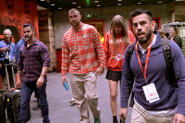 Travis Kelce, seen here in October leaving a Kansas City Chiefs game with his girlfriend, Taylor Swift, has apparently convinced Swift's father to root for the Chiefs.