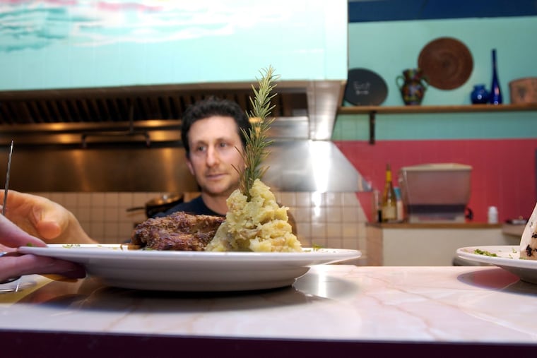 Rich Landau, chef and owner of Horizons Cafe in Willow Grove, overseeing a pecan-and-sage baked seitan dish leaving the kitchen on Jan. 7, 2003.
