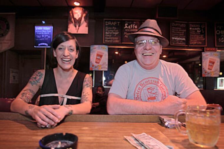 Photographer Sarah Stolfa, who always shot her subjects alone, joins one of them, David Scott Smith, at McGlinchey’s bar. (DAVID M WARREN / Staff Photographer)