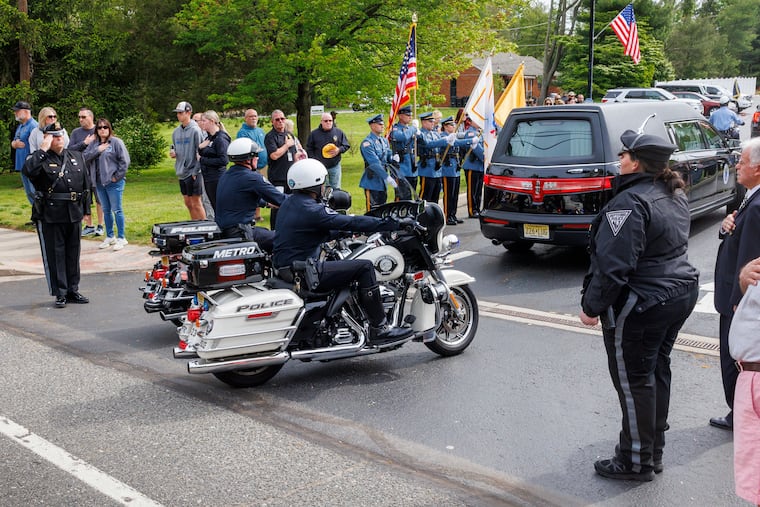 Procession of police vehicles escorting the body of officer Bobby Shisler.