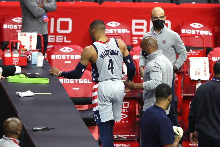 Russell Westbrook of the Wizards is helped off the court after suffering an injury in th fourth quarter of Game 2.