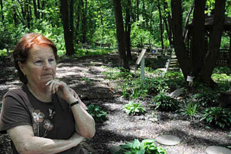Marilyn Dougherty at the Living Memorial Gardens, where people who've lost loved ones to violence can come to heal. Her son was murdered in 1979. (Sarah J. Glover / Staff)