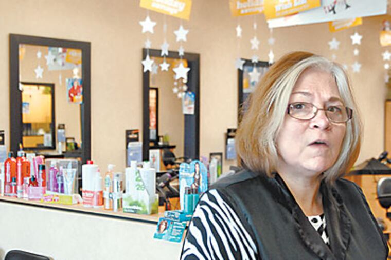 Stylist Patti Herman of Jim Thorpe between cuts at Holiday Hair in Schnecksville on Wednesday. (Tom Gralish / Staff Photographer)