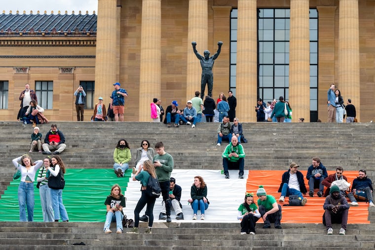 A large Irish flag is on the “Rocky Steps” of the Philadelphia Museum of Art Sunday, Mar. 16, 2025 as spectators and others watch the annual St. Patrick's Day Parade. The grand marshal this year was Paddy Rooney and the parade theme a tribute to first responders: “St. Patrick, Bless Those Dedicated to Serving Others”