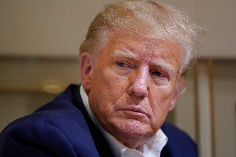 Former President Donald Trump listens as he speaks with reporters while in flight on his plane following a campaign rally at Waco Regional Airport, in Waco, Texas, on March 25, 2023.