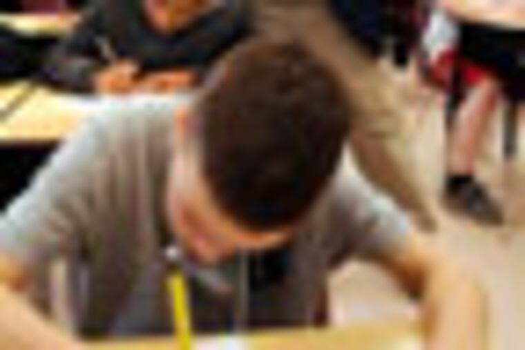 Columnist Kevin Riordan (cq) walks around the classroom, checking on students progress on his essay writing assignment as he tries to teach them a thing or two March 15, 2012 in 5th grade teacher Denise Roskey's class at the Kilmer School in Cherry Hill. He's looking over Jason Califf-Wescott (cq), Avery Bermudez (cq) is in front. No id on kid rear, right. ( TOM GRALISH / Staff Photographer )