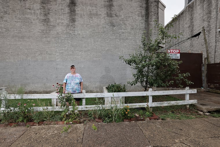 Joan Dansette stands in the garden she tends on a vacant lot at 2000 Hart Lane in Philadelphia on Friday, July 12, 2024. Joan’s daughter, 14-year-old Riley Dansette, named the garden The Lily Flower Garden.