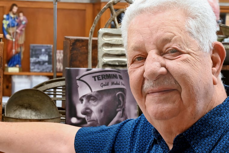 Vincent Termini Sr. stands next to a portrait of his father, Giuseppe "Joe" Termini, in the bakery in 2023.