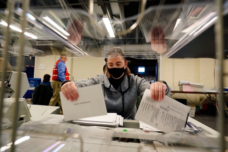 Chester County, Pa., election worker Kristina Sladek opens mail-in and absentee ballots for the 2020 General Election in the United States at West Chester University Tuesday in West Chester, Pa.