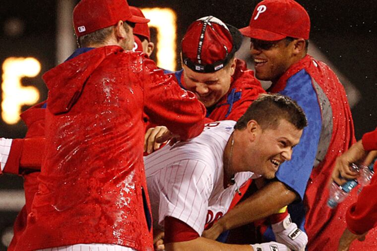 Reid Brignac is swarmed by his teammates after his game-winning single in the 14th inning. (Ron Cortes/Staff Photographer)