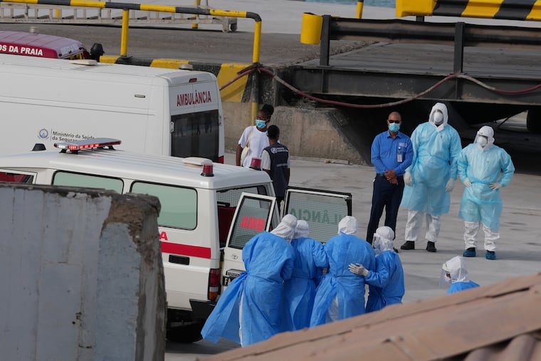 Health workers in protective gear evacuate patients from the MV Hondius cruise ship into an ambulance at a port in Praia, Cape Verde, on Wednesday.