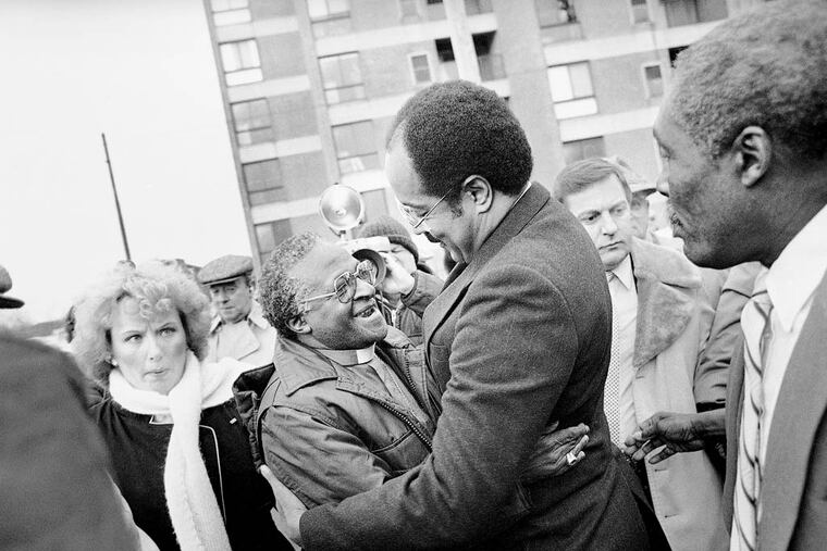 Bishop Desmond Tutu, left, is greeted by Rep. William H. Gray III, who just returned from a trip to South Africa, outside Philadelphia's Bright Hope Baptist Church, Jan. 14, 1986. Tutu attended a breakfast there sponsored by the Black Clergy of Philadelphia and Vicinity, the Jewish Community Relations Council of Greater Philadelphia and the Board of Rabbis of Greater Philadelphia. (AP Photo/Peter Morgan)