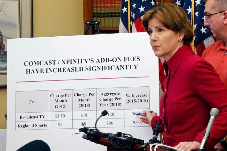 Minnesota Attorney General Lori Swanson announces Friday, Dec. 21, 2018 in St. Paul, Minn. the filing of a lawsuit against Comcast/Xfinity, alleging the company has overcharged thousands of consumers for cable TV packages, charged them for unordered equipment and services, and failed to deliver on promised Visa gift cards. (AP Photo/Jim Mone)