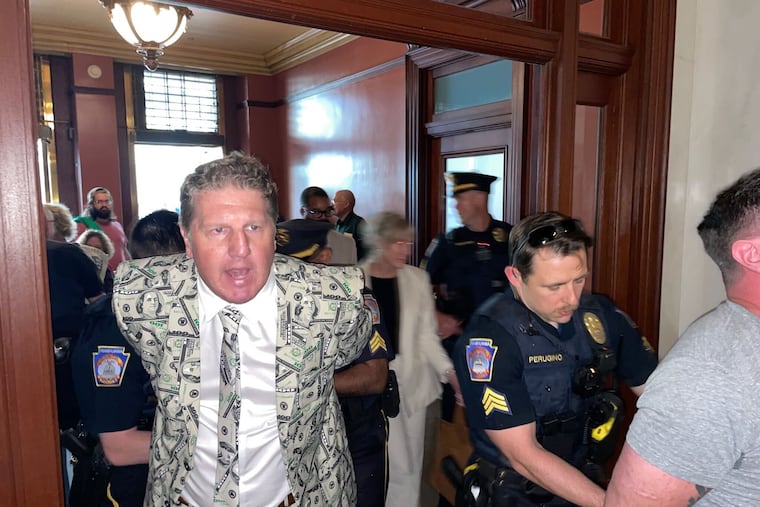 A protester with anti-corruption group March on Harrisburg is arrested after blocking a hallway in the Pennsylvania state Capitol building on Monday, May 4. He was among nine protesters arrested as part of the group's sit-in.