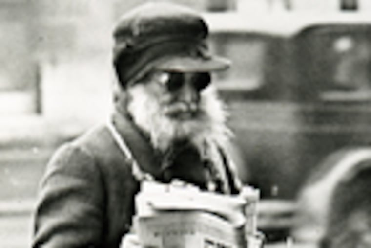 A man sells copies of the Daily Forward in a photograph from "A Living Lens," a compilation of scenes from the paper.