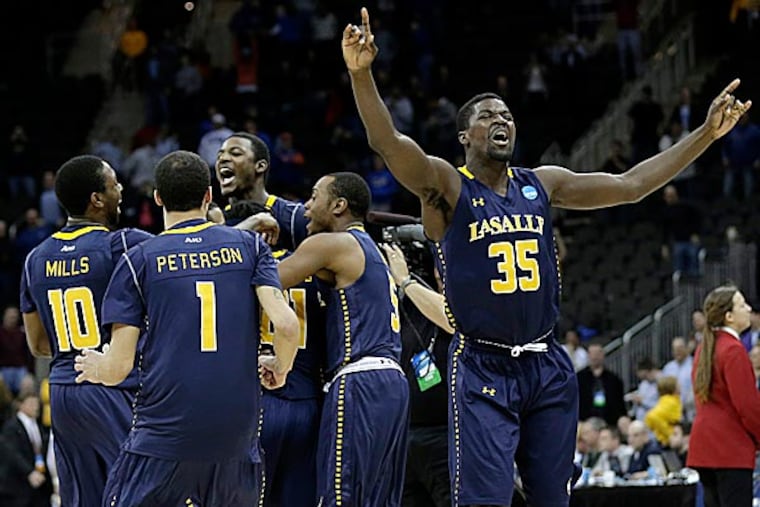 La Salle players are reveling in the joy much more than their coach. (Charlie Riedel/AP)