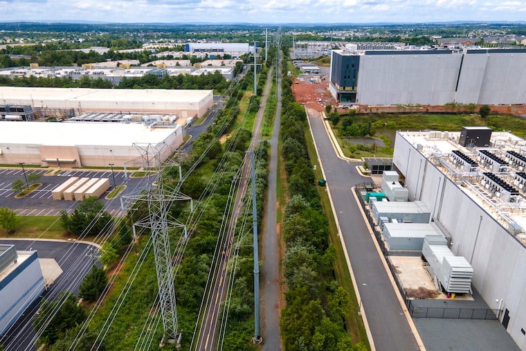 High-voltage transmission lines provide electricity to data centers in Ashburn, Va. Big Tech companies are pouring money into massive data centers and the energy systems needed to run them, and are issuing corporate bonds to finance them.